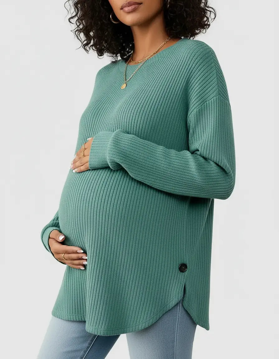 Pregnant woman in a soft-knit, relaxed-fit teal maternity sweatshirt with ribbed texture and side buttons.