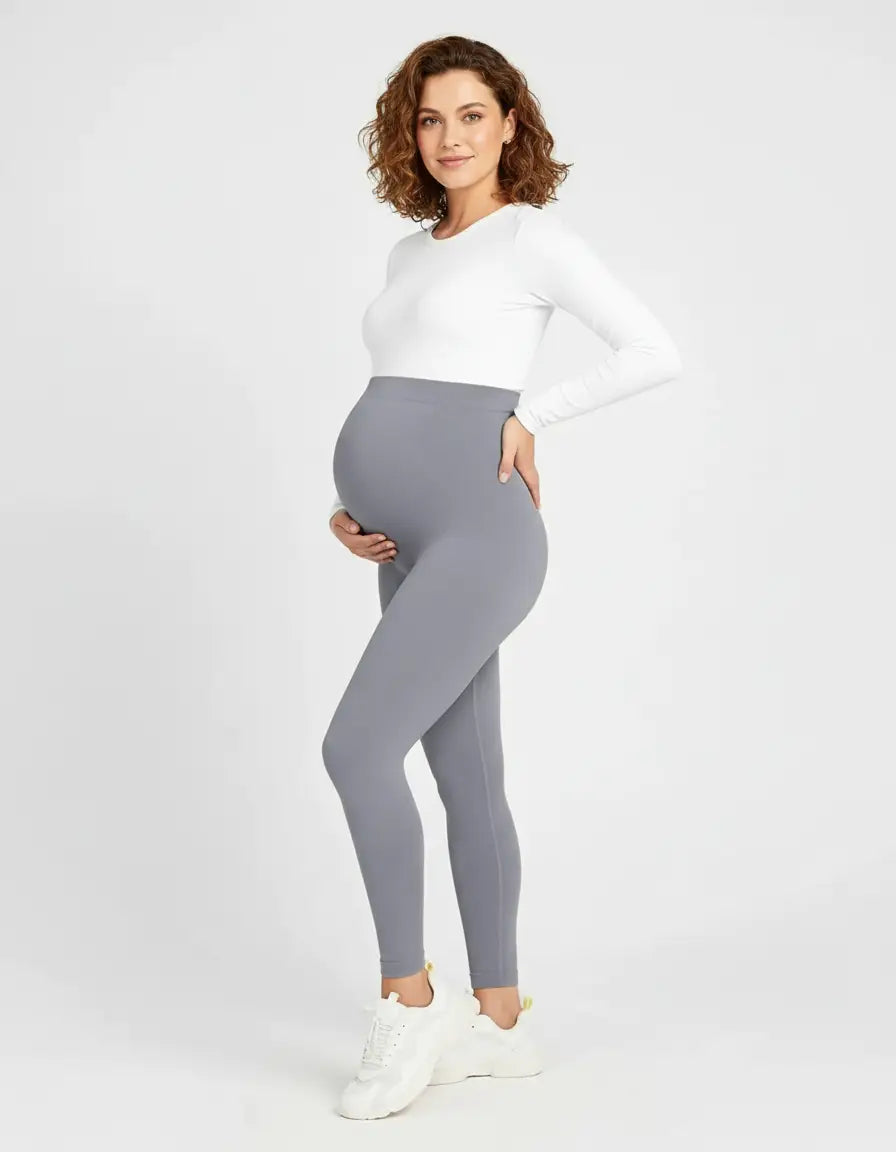 Pregnant woman in soft-stretch, full-length gray maternity leggings with an over-the-bump waistband.