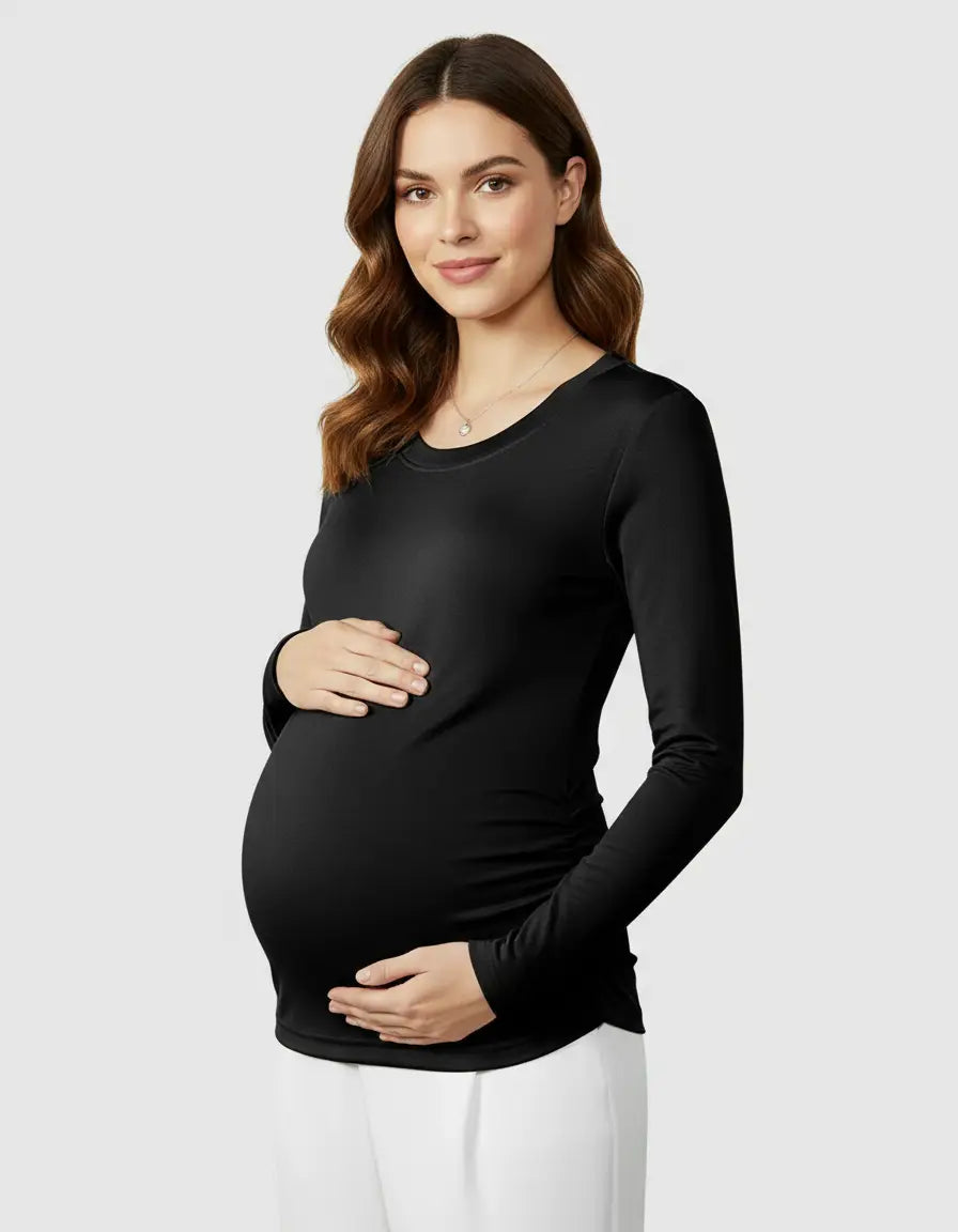 Pregnant woman in a black, soft thermal long-sleeve maternity top with ruched sides.