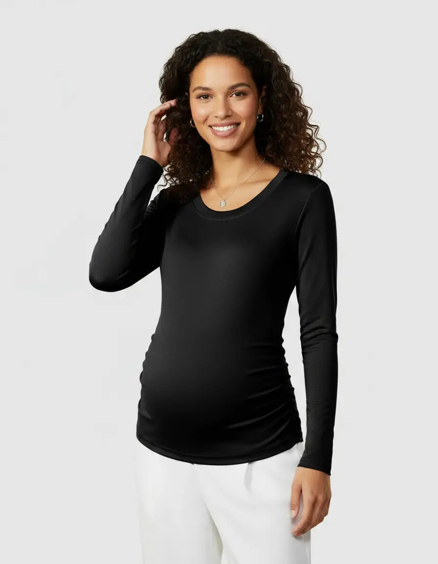 Smiling pregnant woman in a black thermal long-sleeve maternity top with side ruching.