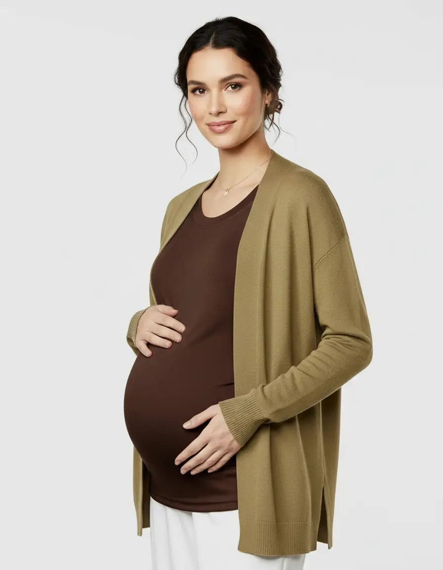 Pregnant woman in a brown thermal long sleeve maternity top with a relaxed fit, layered under an olive cardigan.