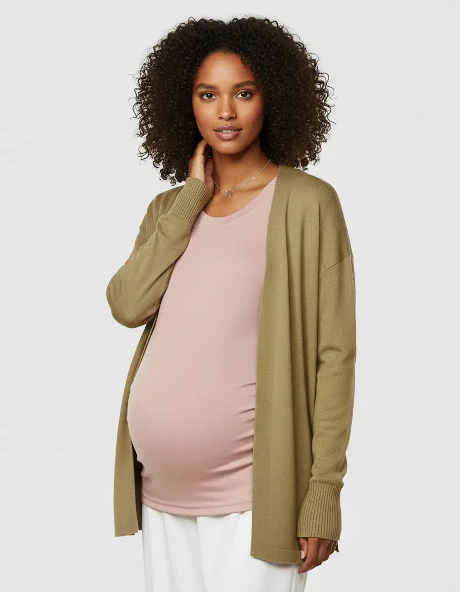 Pregnant woman wearing a pink thermal long sleeve maternity top under an olive green cardigan.