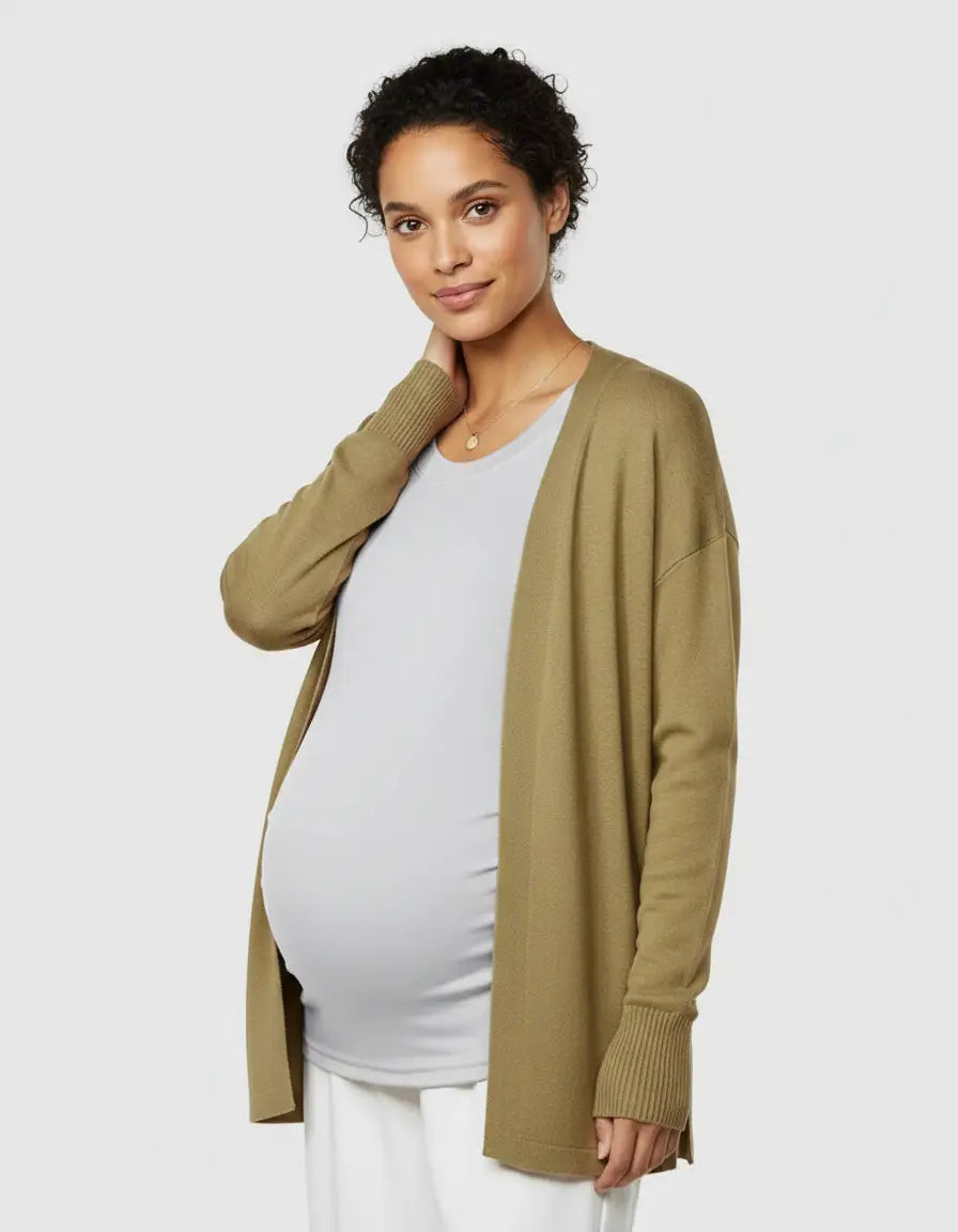 Pregnant woman in a light grey thermal long sleeve maternity top and an olive green cardigan.