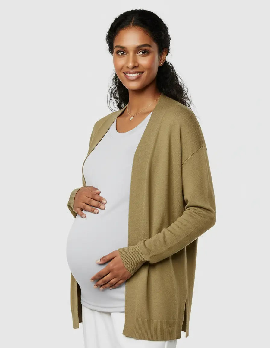 Smiling pregnant woman wearing a light grey thermal long sleeve maternity top and an olive green cardigan.
