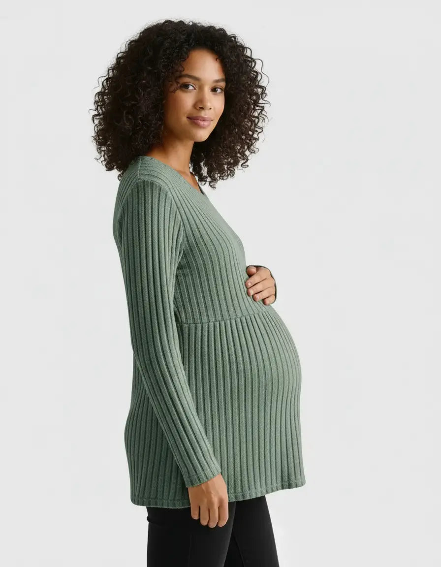 Pregnant woman in a sage green stretch-ribbed casual-fit maternity top with long sleeves.