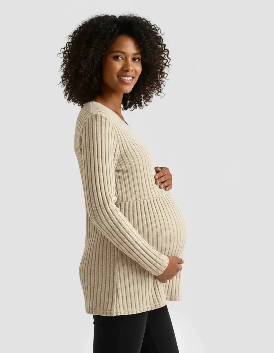Smiling pregnant woman in a beige stretch-ribbed casual-fit maternity top with long sleeves.