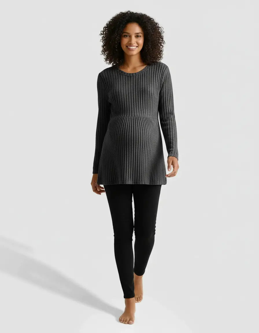 Smiling pregnant woman in a gray stretch-ribbed casual-fit maternity top and black pants.