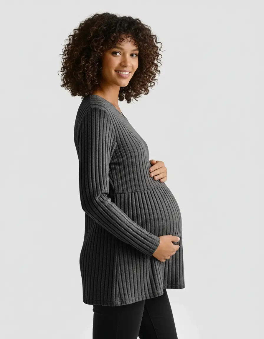 Smiling pregnant woman in a charcoal gray stretch-ribbed casual-fit maternity top, holding her belly.