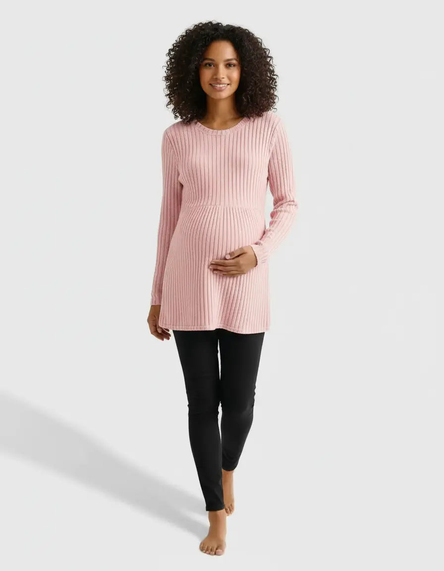 Smiling pregnant woman in a pink stretch-ribbed casual-fit maternity top and black pants.