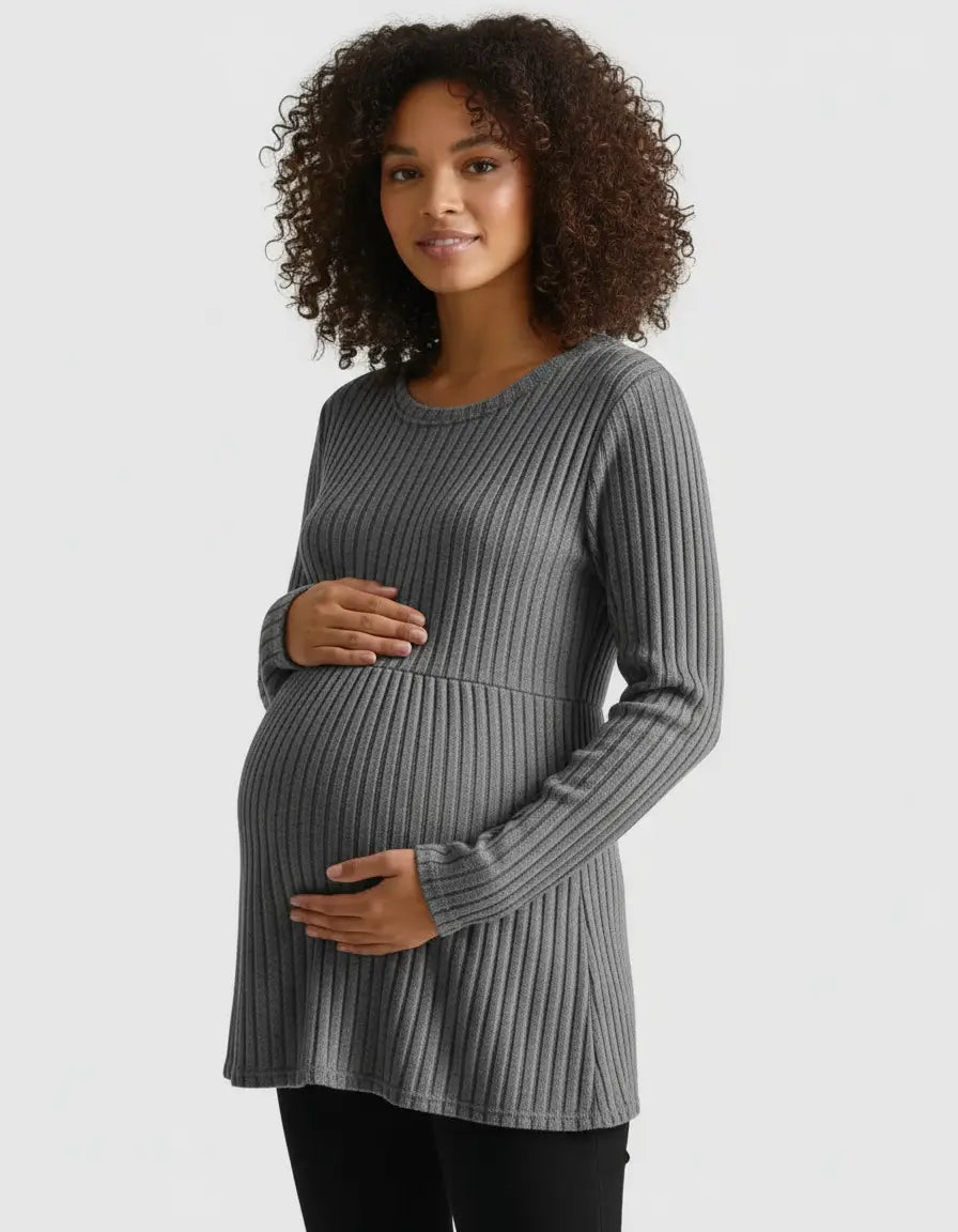 Pregnant woman in a gray stretch-ribbed long-sleeve maternity top, hands cradling her bump.