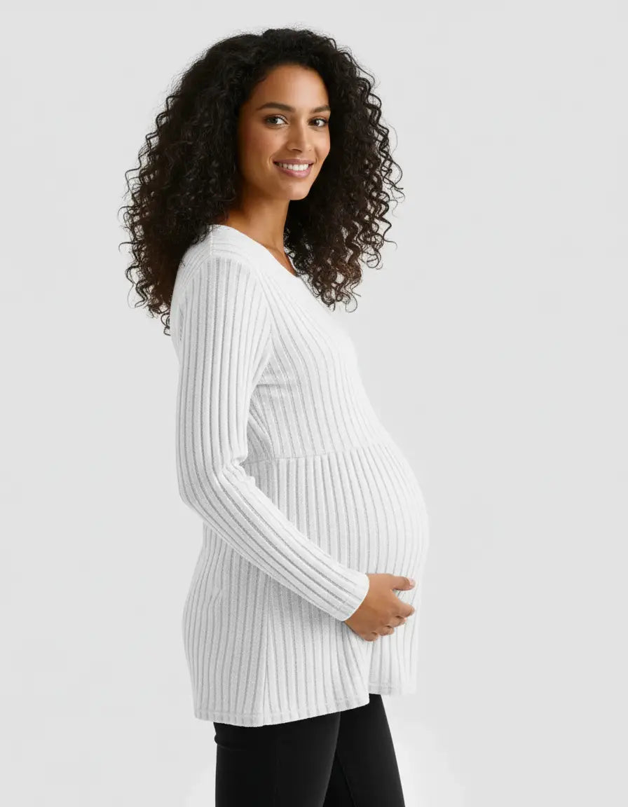 Smiling pregnant woman in a white stretch-ribbed casual-fit maternity top with long sleeves.