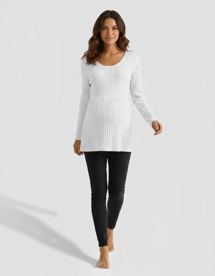 Woman models white stretch-ribbed maternity top with scoop neck and long sleeves, paired with black pants.