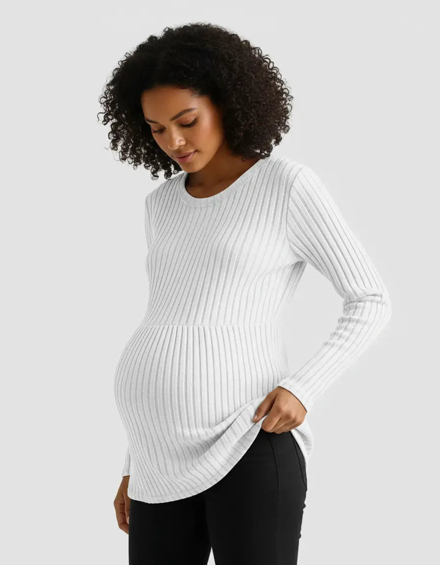 Pregnant woman in a white stretch-ribbed long-sleeve maternity top with a casual fit.