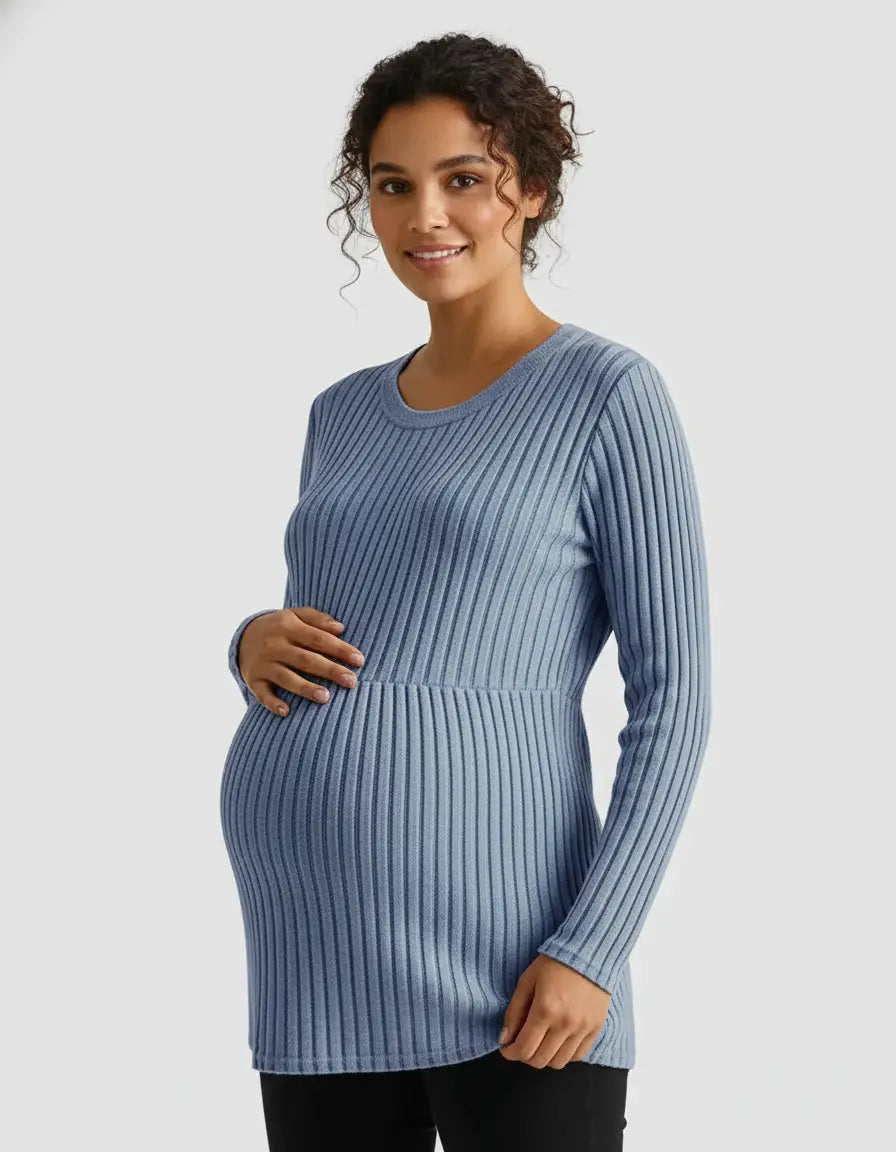 Smiling pregnant woman in a blue stretch-ribbed casual-fit maternity top, hand on belly.