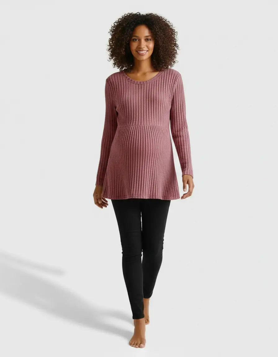 Smiling pregnant woman in a pink stretch-ribbed casual-fit maternity top and black pants.