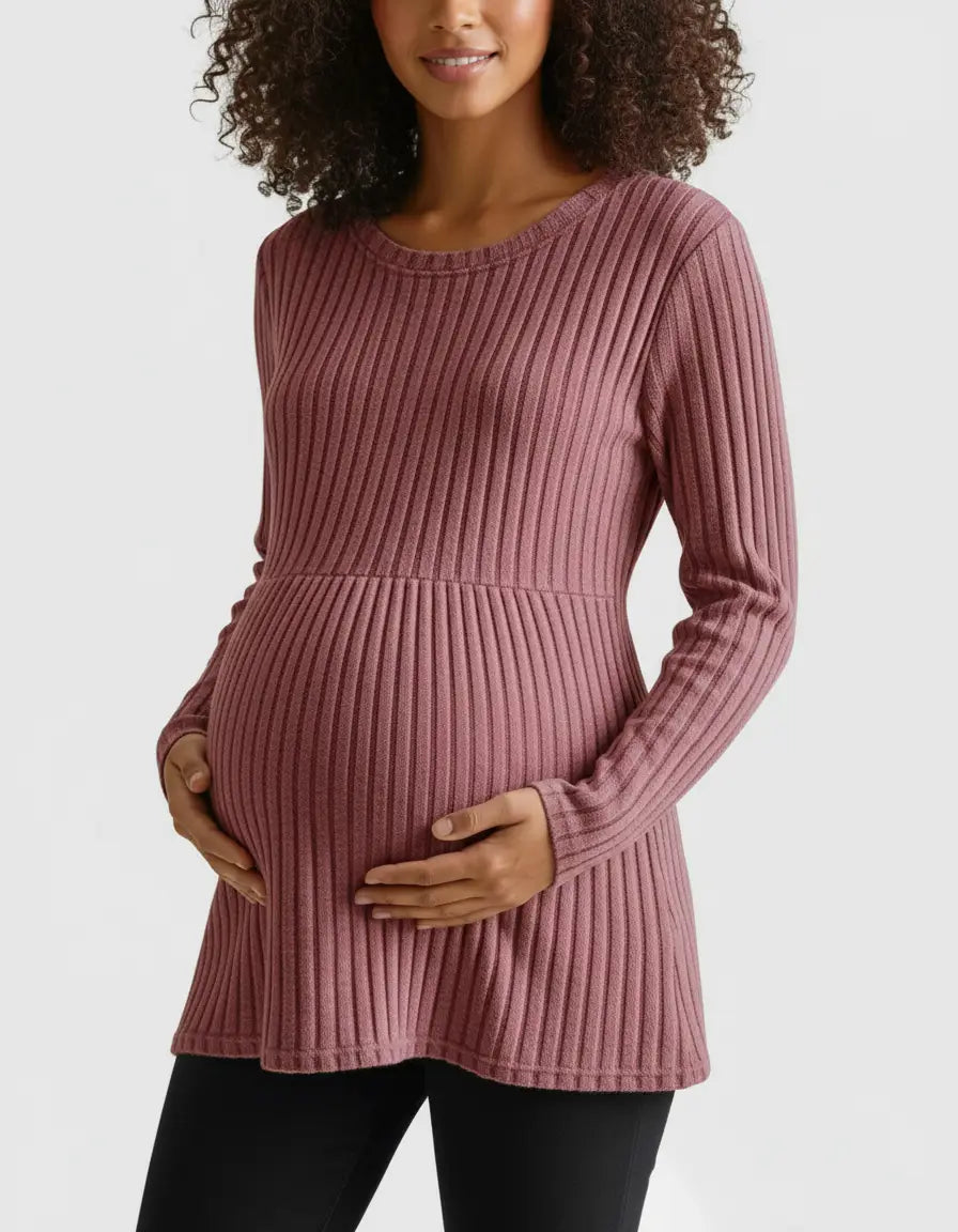 Smiling pregnant woman in a pink stretch-ribbed casual-fit maternity top, holding her belly.