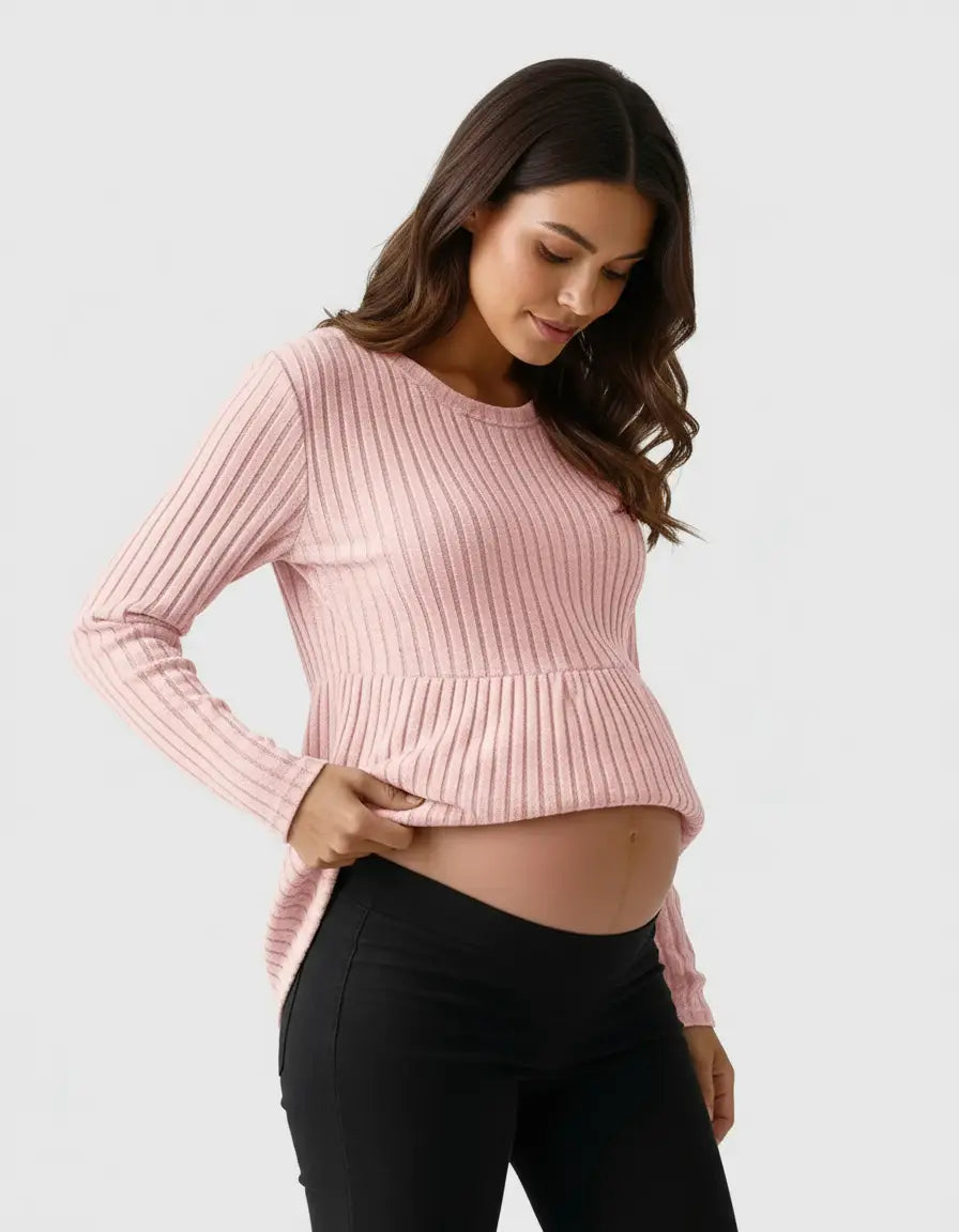 Pregnant woman in a pink stretch-ribbed casual-fit maternity top with a peplum hem.
