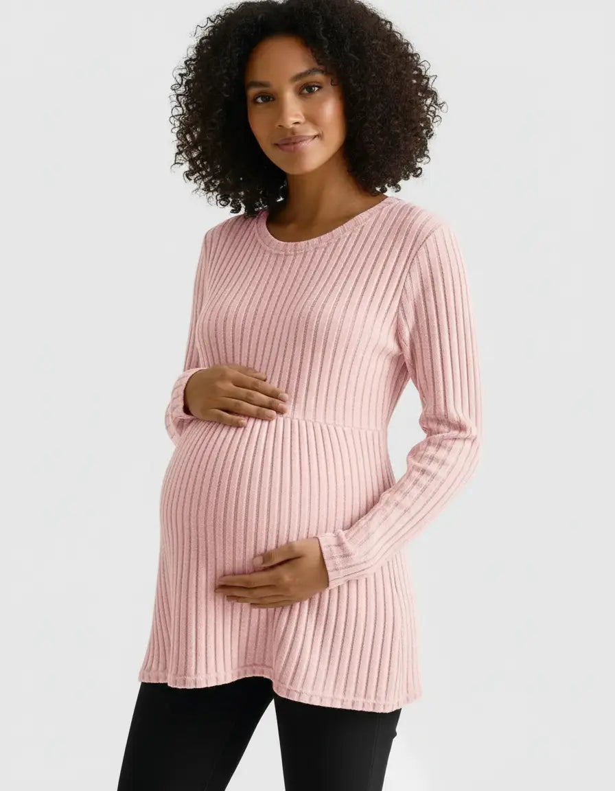 Smiling pregnant woman in a pink stretch-ribbed casual-fit maternity top, holding her belly.