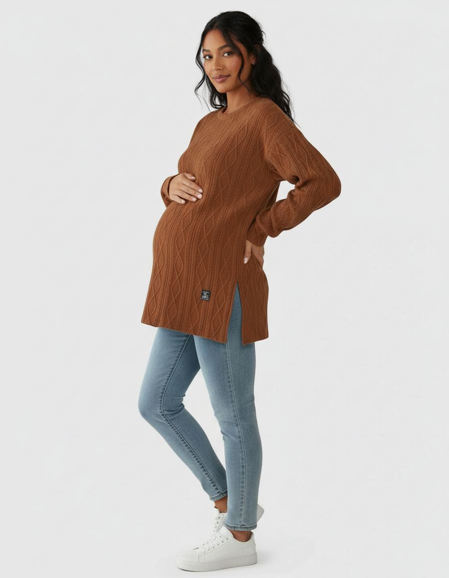 Pregnant woman in a brown textured loose-fit maternity top with side slits and light blue jeans.