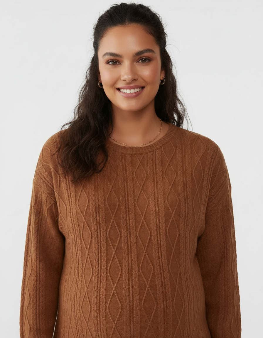 Smiling woman wearing a brown textured loose-fit maternity top with cable knit pattern.