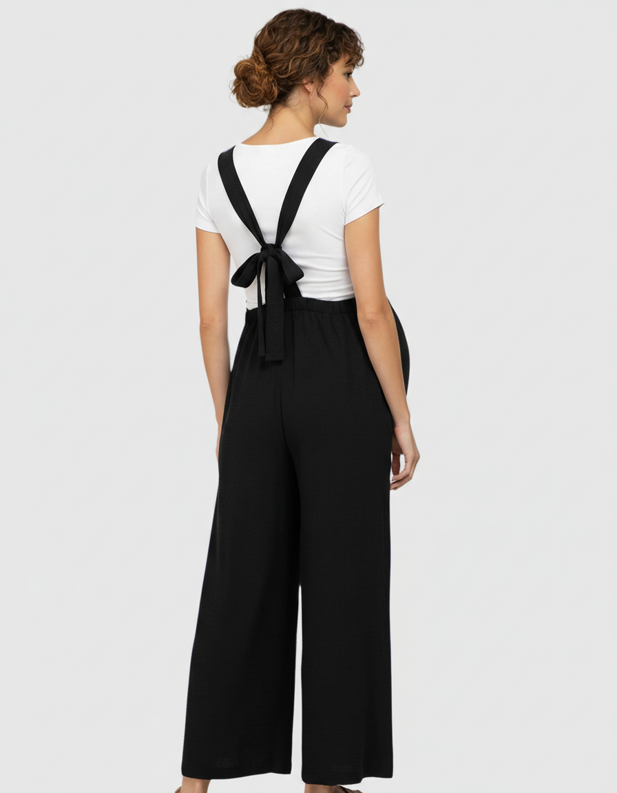 Black tie-back wide-leg maternity jumpsuit over a white tee, designed for comfort and a relaxed fit.