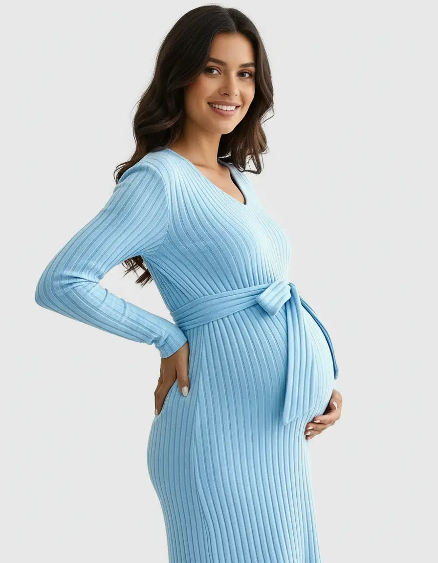 Smiling pregnant woman in a light blue ribbed tie-waist maternity top with long sleeves.
