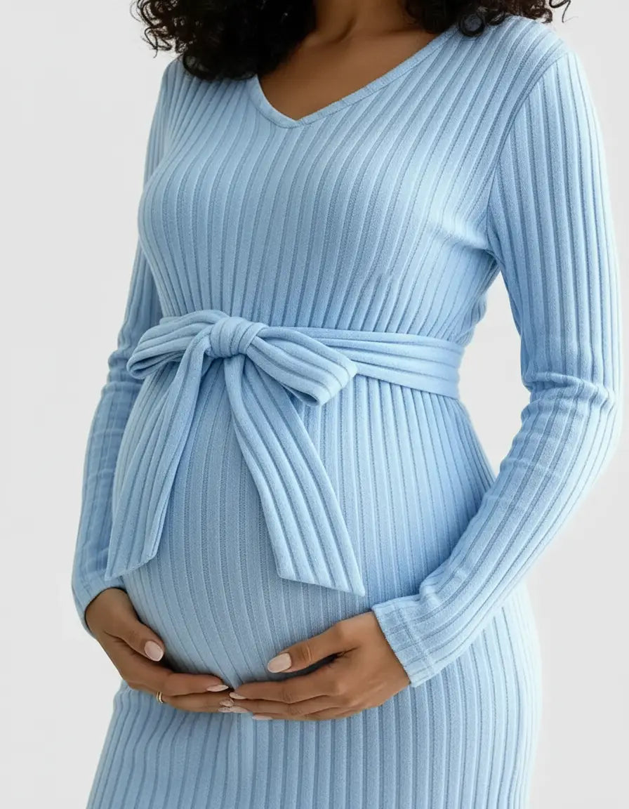 Maternity model in a light blue ribbed tie-waist top, showcasing a comfortable, relaxed fit.