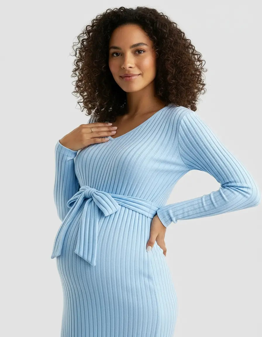 Maternity model in a light blue ribbed tie-waist top, showcasing its comfortable, adaptable fit.