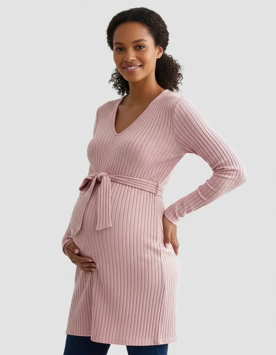 Smiling pregnant woman in a pink ribbed tie-waist maternity top with V-neck and long sleeves.