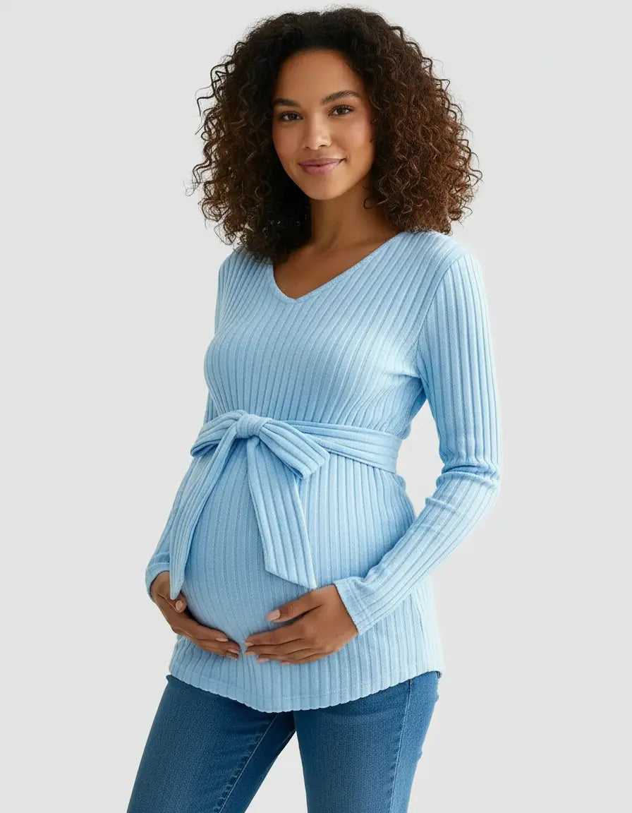 Pregnant woman in a light blue ribbed tie-waist maternity top with a V-neck and long sleeves.