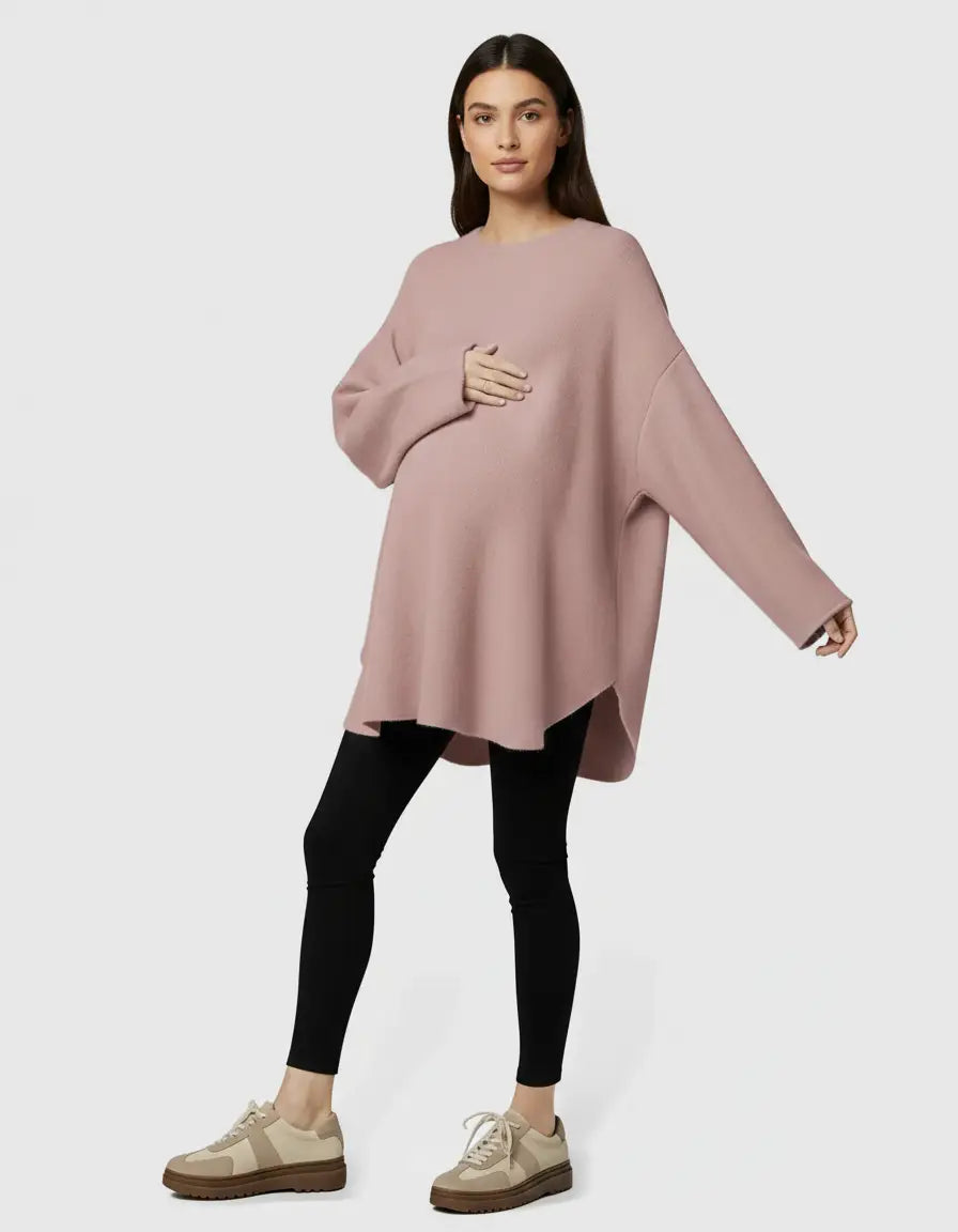 Pink wool blend relaxed maternity sweater with a high-low hem, worn by a pregnant woman.