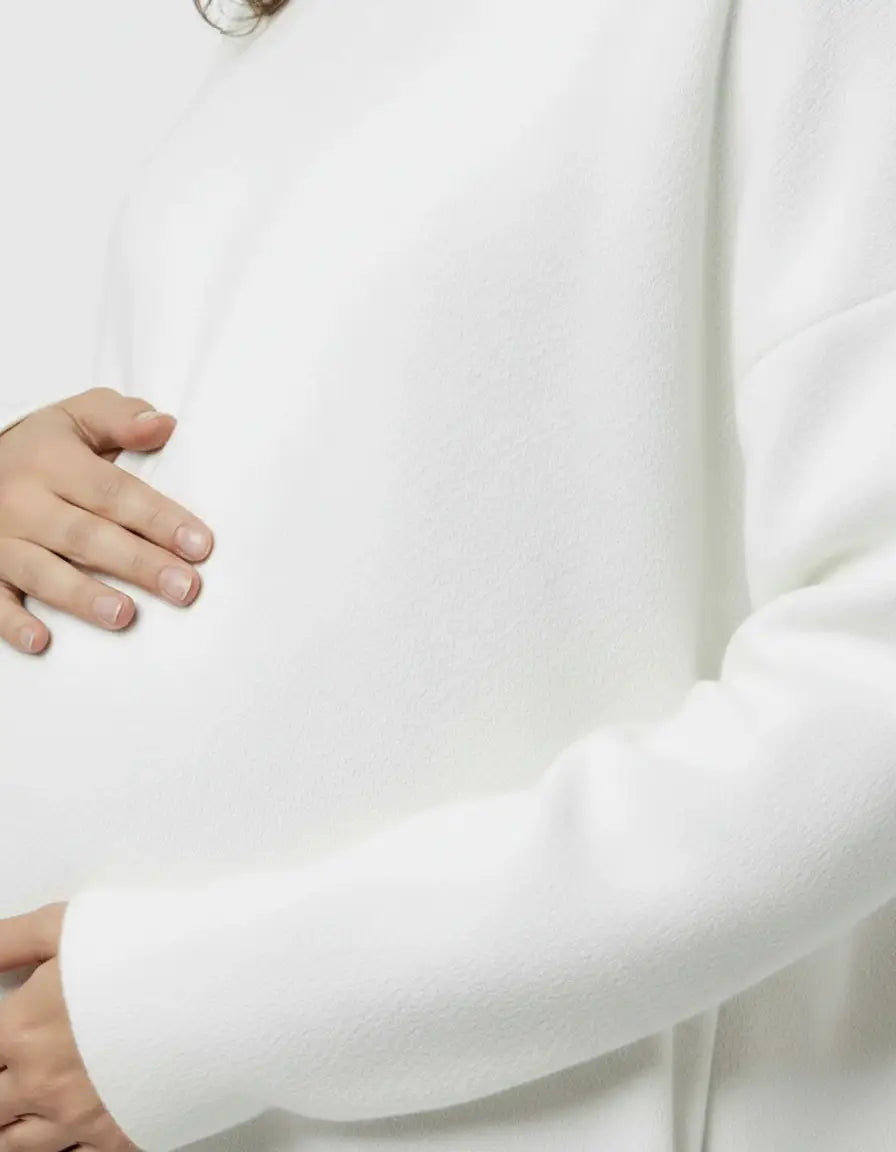 White wool blend relaxed style maternity sweater with a bump-friendly fit.