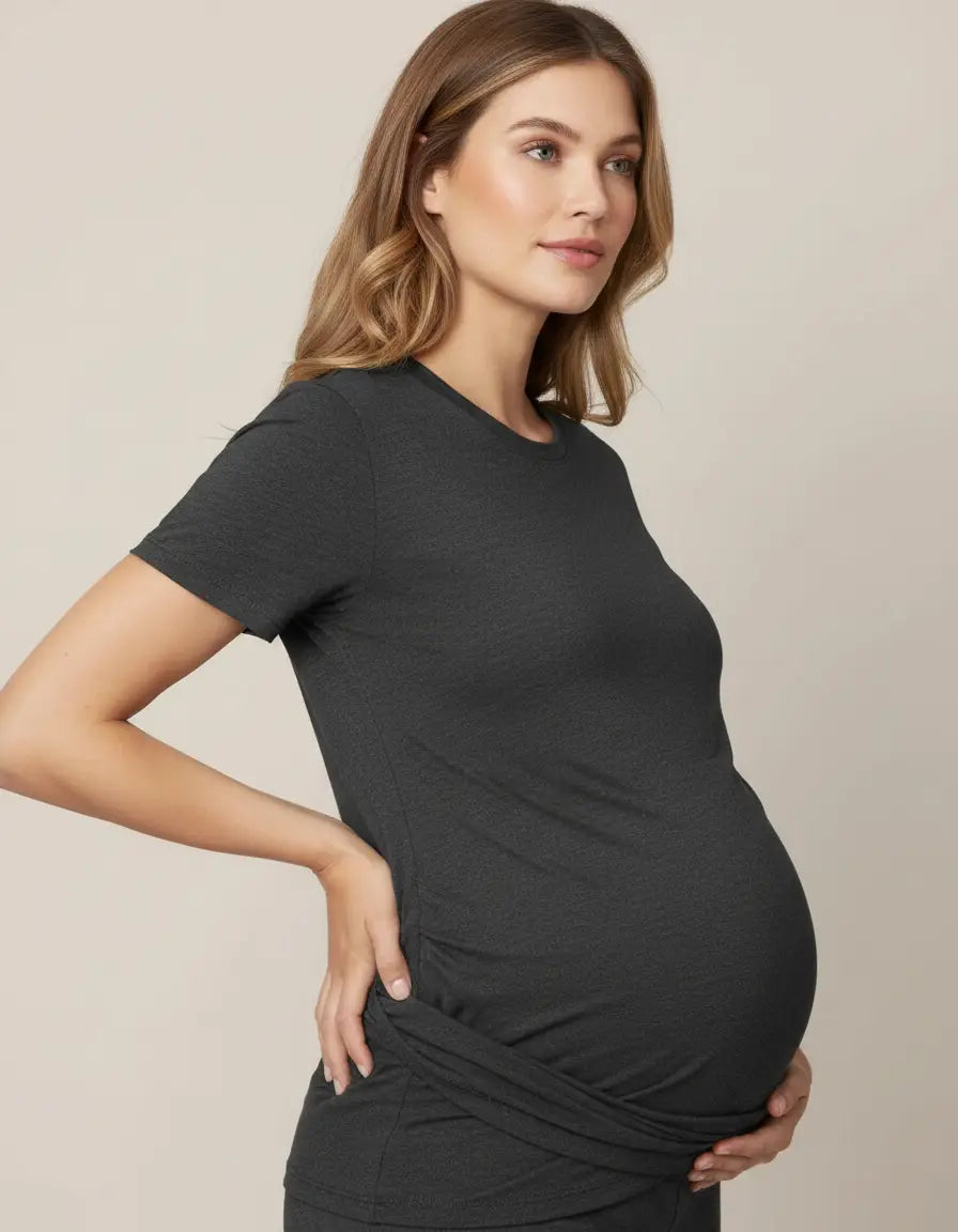 Pregnant woman in a charcoal gray, short-sleeve 3-in-1 skin-to-skin nursing wrap top.