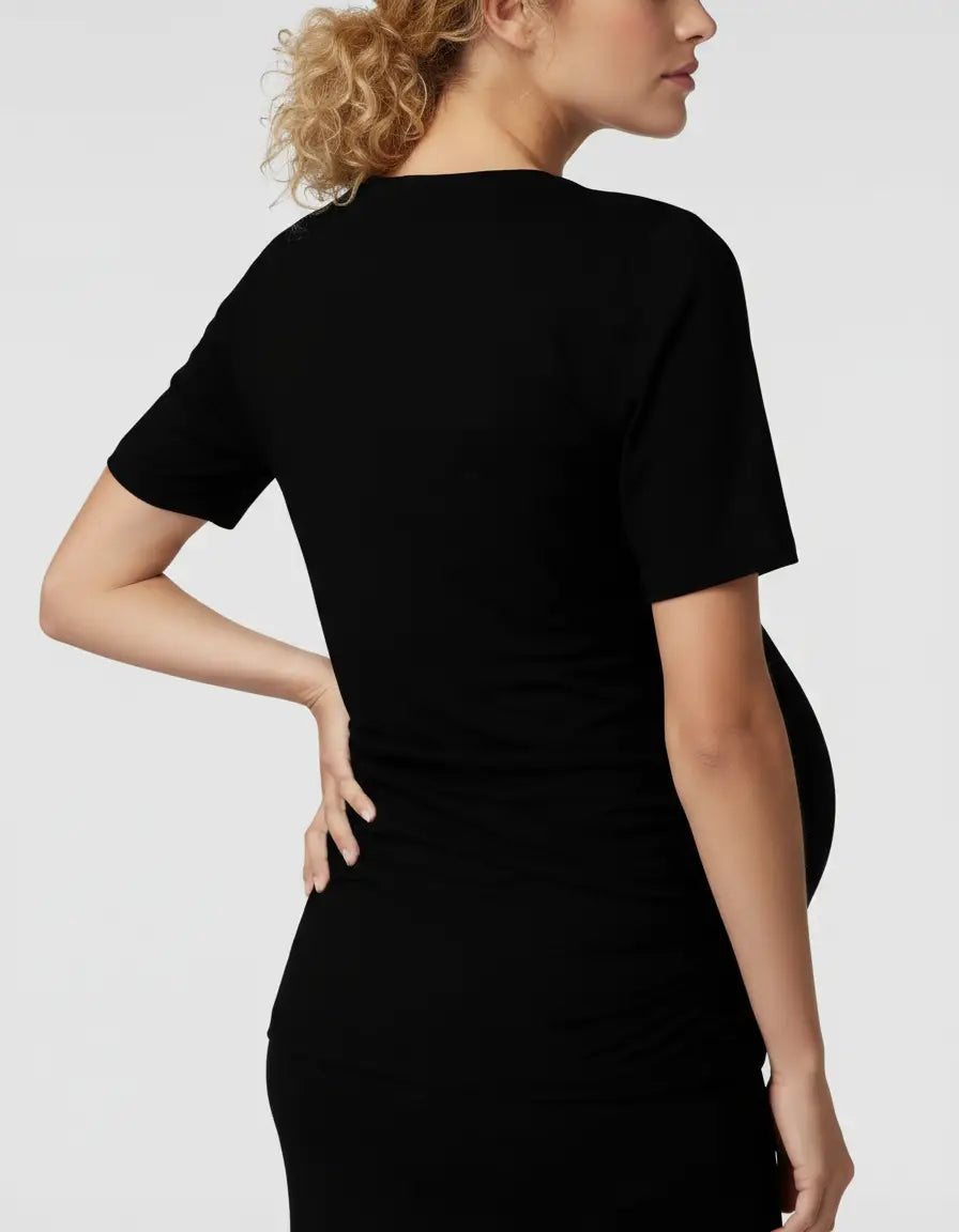 Black 3-in-1 skin-to-skin nursing wrap top on a pregnant model, showing the back and side profile.
