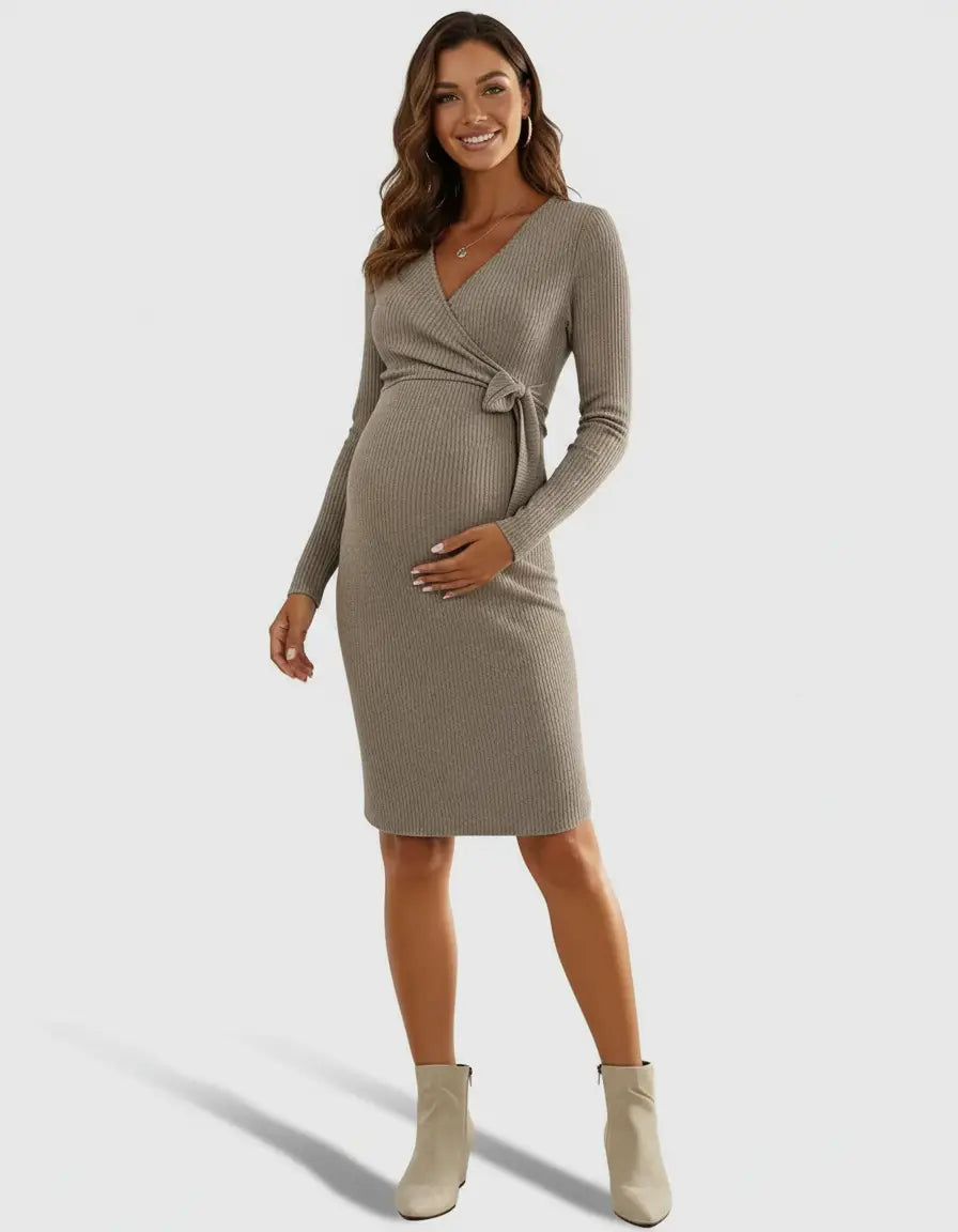 Maternity model in a taupe ribbed knit wrap midi dress with long sleeves and a tie waist.