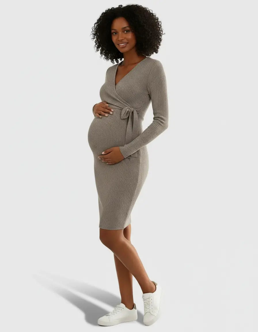 Pregnant woman in a taupe ribbed knit wrap midi dress with a tie waist, long sleeves, and V-neck.
