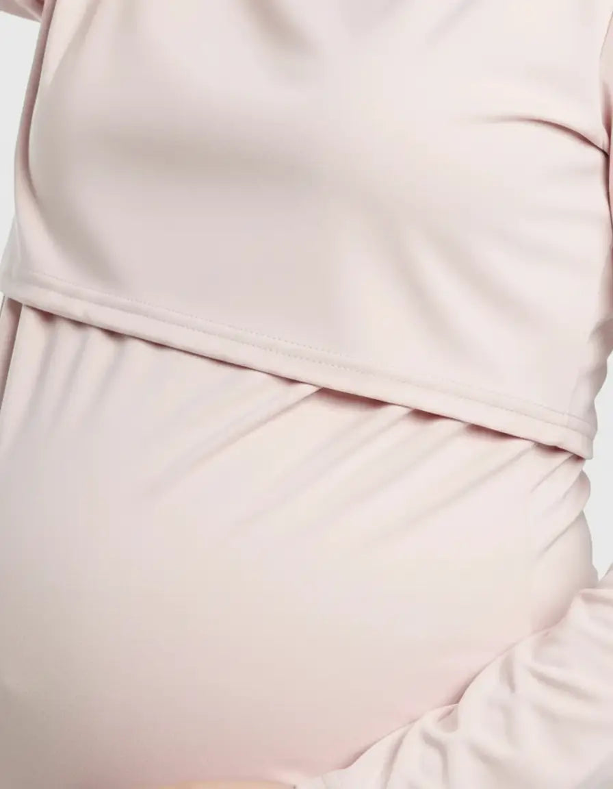 Light pink round neck nursing top with feeding port, soft and flexible for pregnancy and postpartum.