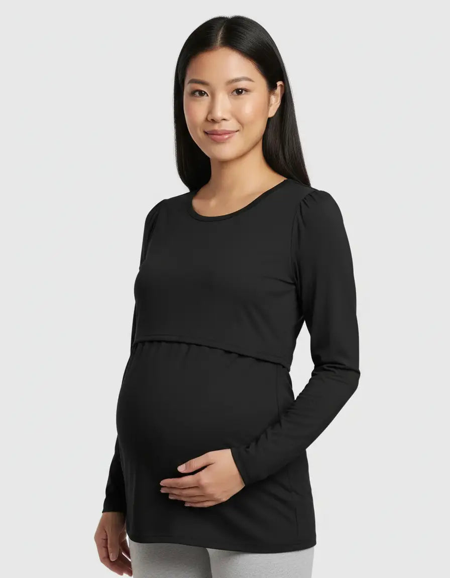 Pregnant woman in a black long-sleeve round neck nursing top with feeding port.