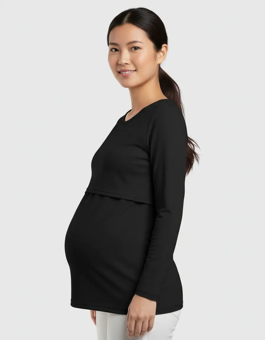 Smiling pregnant woman wearing a black long-sleeve round neck nursing top with feeding port.