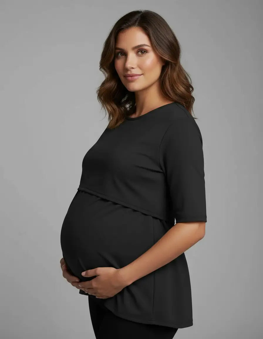 Pregnant woman in a black round neck nursing top with feeding port, designed for comfort.