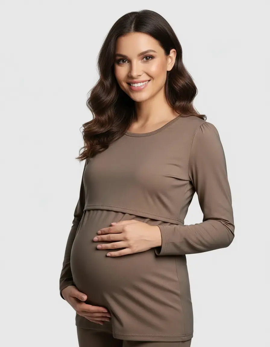 Smiling pregnant woman in a brown long-sleeve round neck nursing top with feeding port.