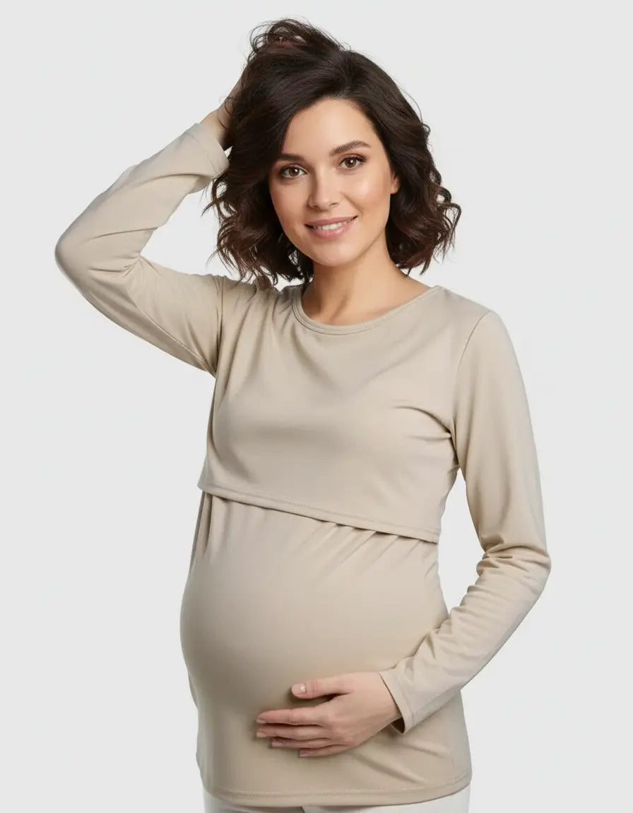 Smiling pregnant woman in a beige long-sleeve round neck nursing top with feeding port.