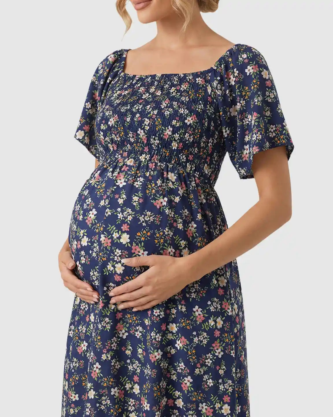 Navy floral flutter-sleeve smocked maternity midi dress with a tiered skirt.