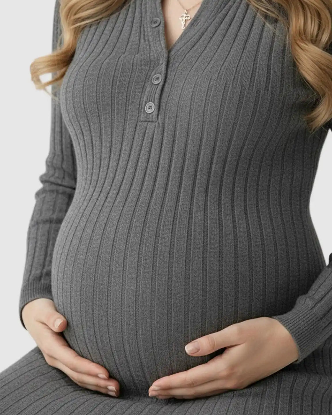 Pregnant woman in a charcoal ribbed knit A-line long sleeve maternity maxi dress with button-up Henley neckline.