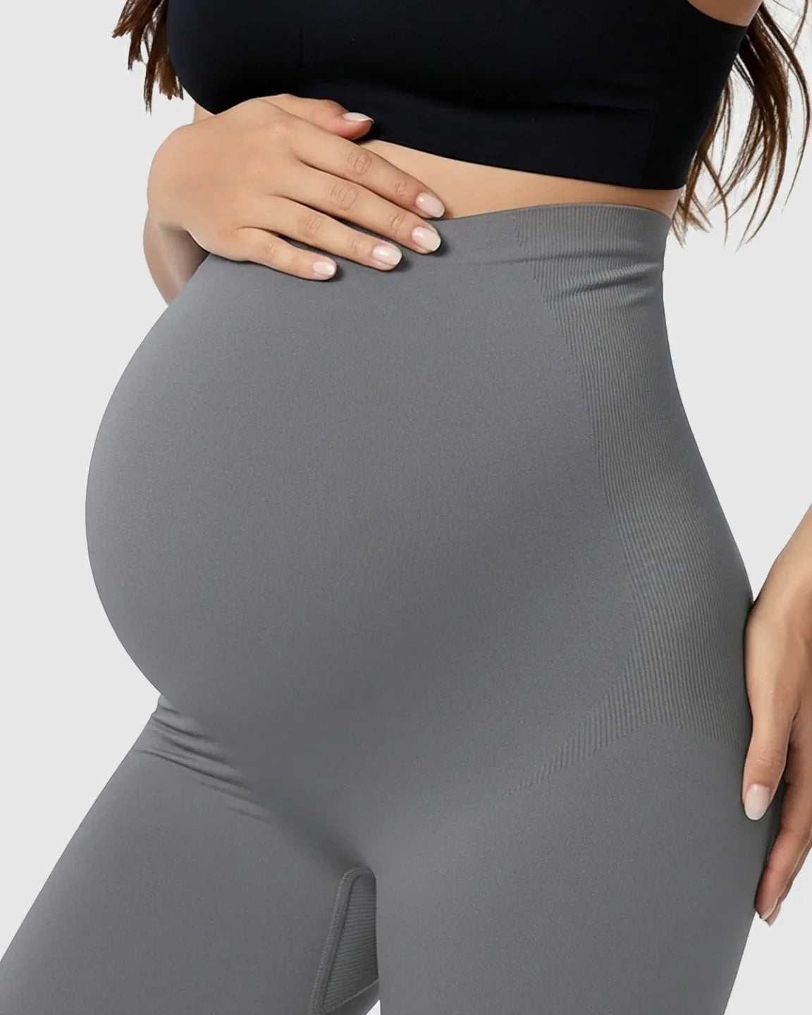 Pregnant woman wearing gray Bump Society Belly Support Stretch Maternity Leggings with ribbed details.