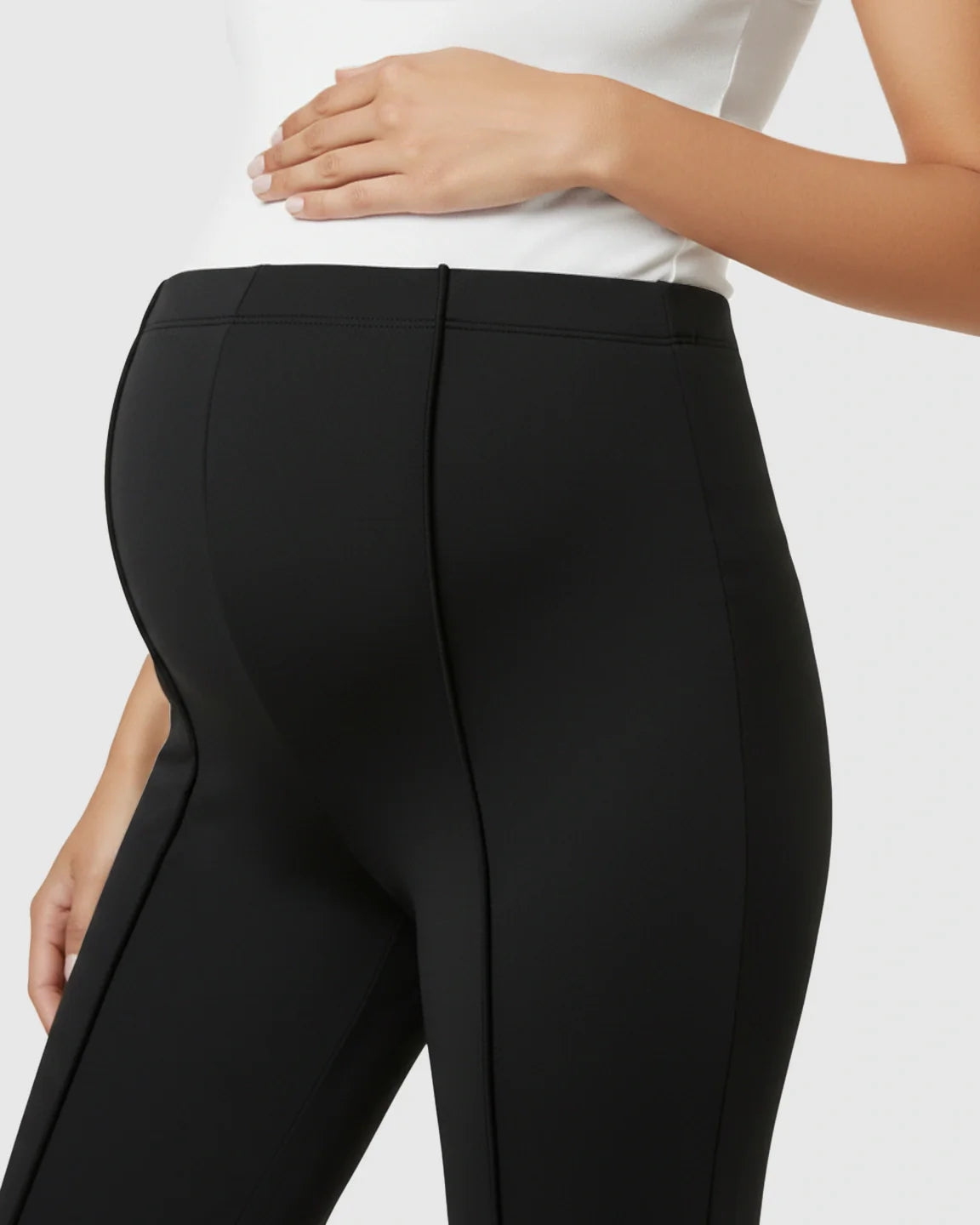 Black butt-lifting flared maternity pants with high over-belly fit, soft stretch fabric, and elegant silhouette.
