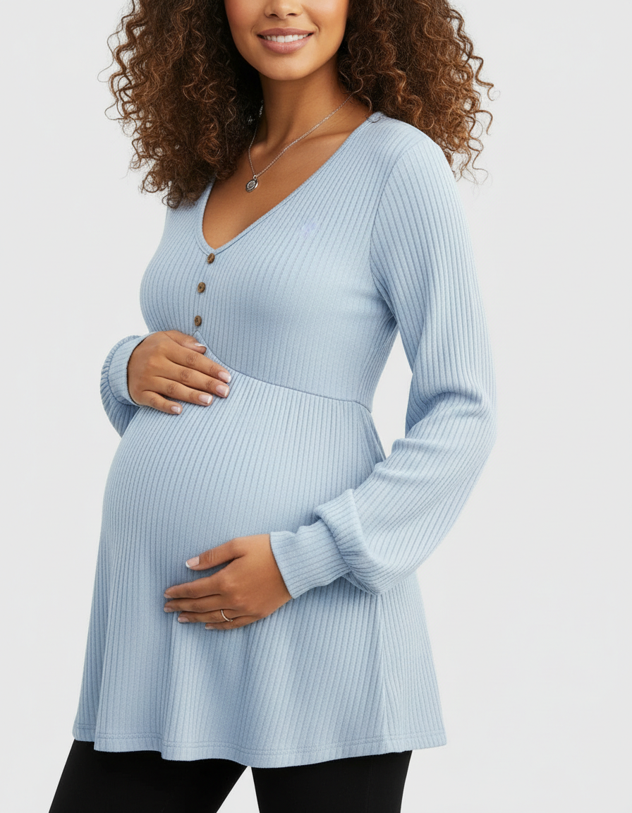 Pregnant woman in a light blue ribbed long-sleeve maternity top with a V-neck and button detail.