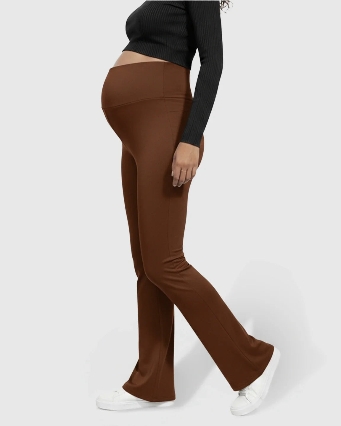 Brown flared maternity pants with a crossed waistband, worn by a pregnant woman.