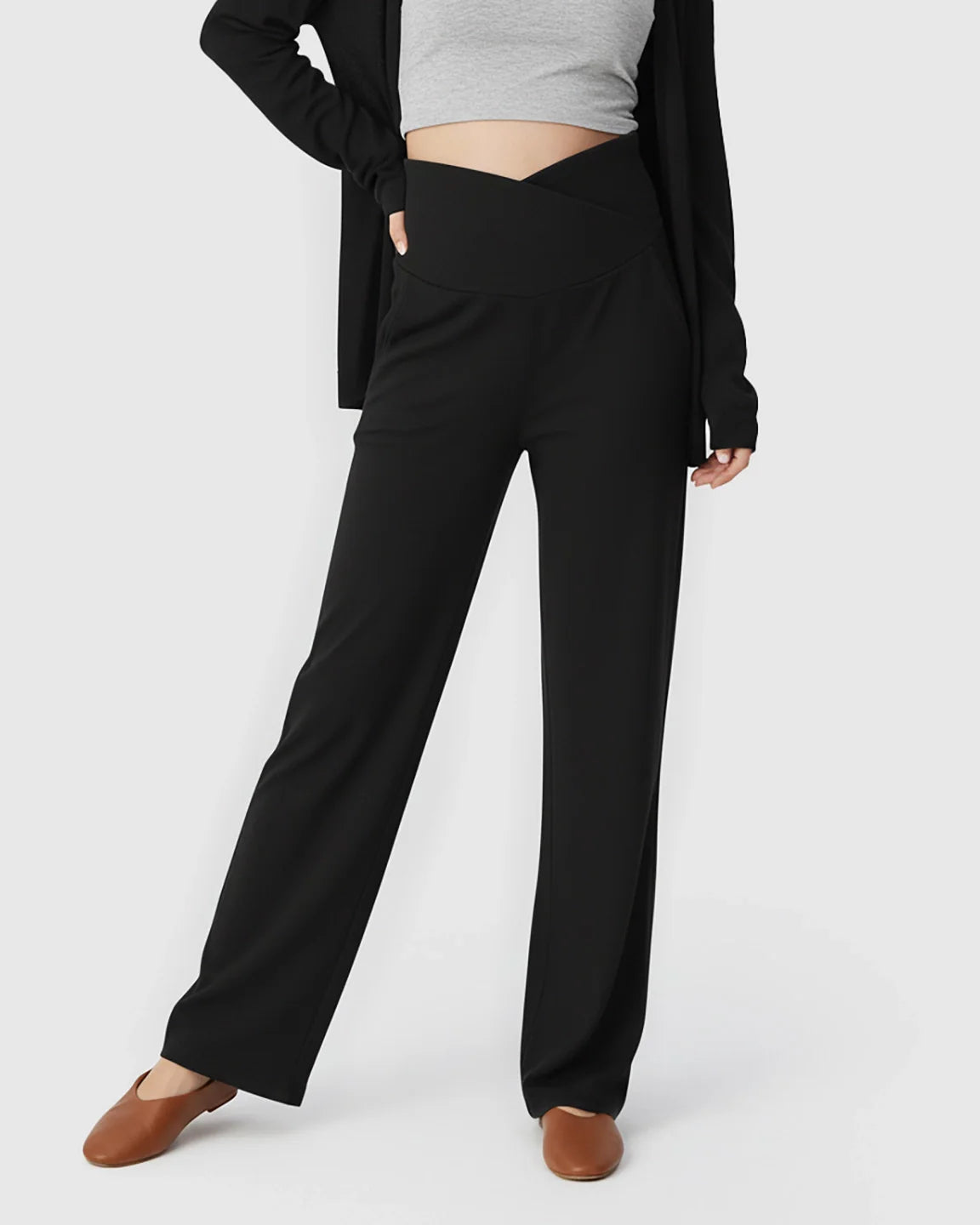 Black wide-leg maternity lounge pants with a crossover waist, styled with a grey crop top and cardigan.