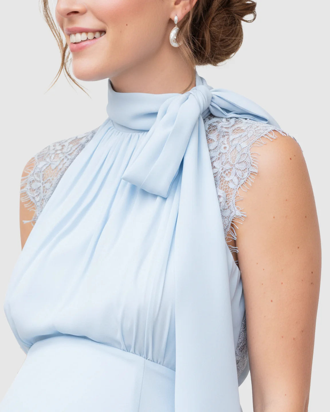 Light blue chiffon maternity midi dress with high neck tie detail and lace shoulders.